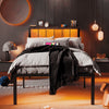 a bed with a black metal frame and a white comforter
